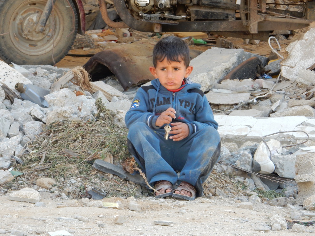 Gaza boy in rubble from Israeli invasion of 2014